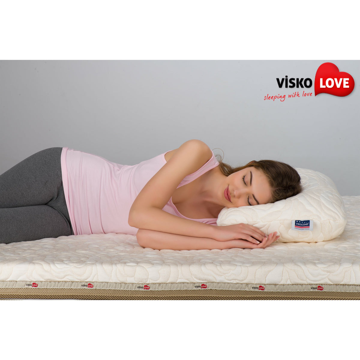 a person laying on a bed with a book 