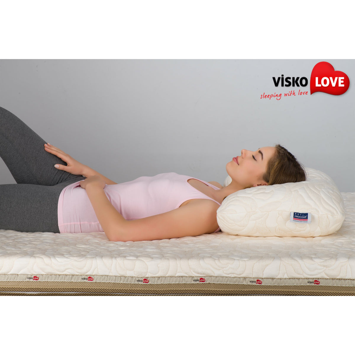 a woman laying in a bed with a book 