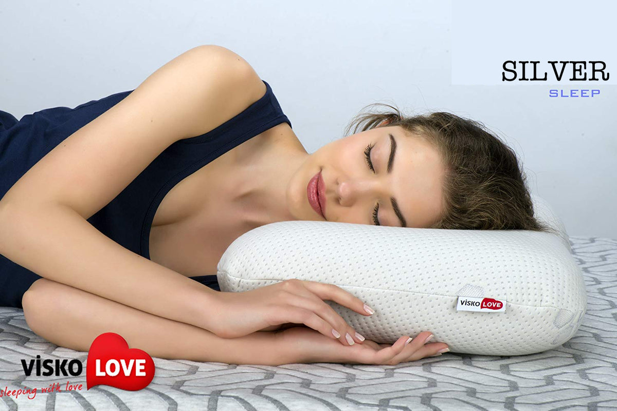 a woman laying in bed reading a book 